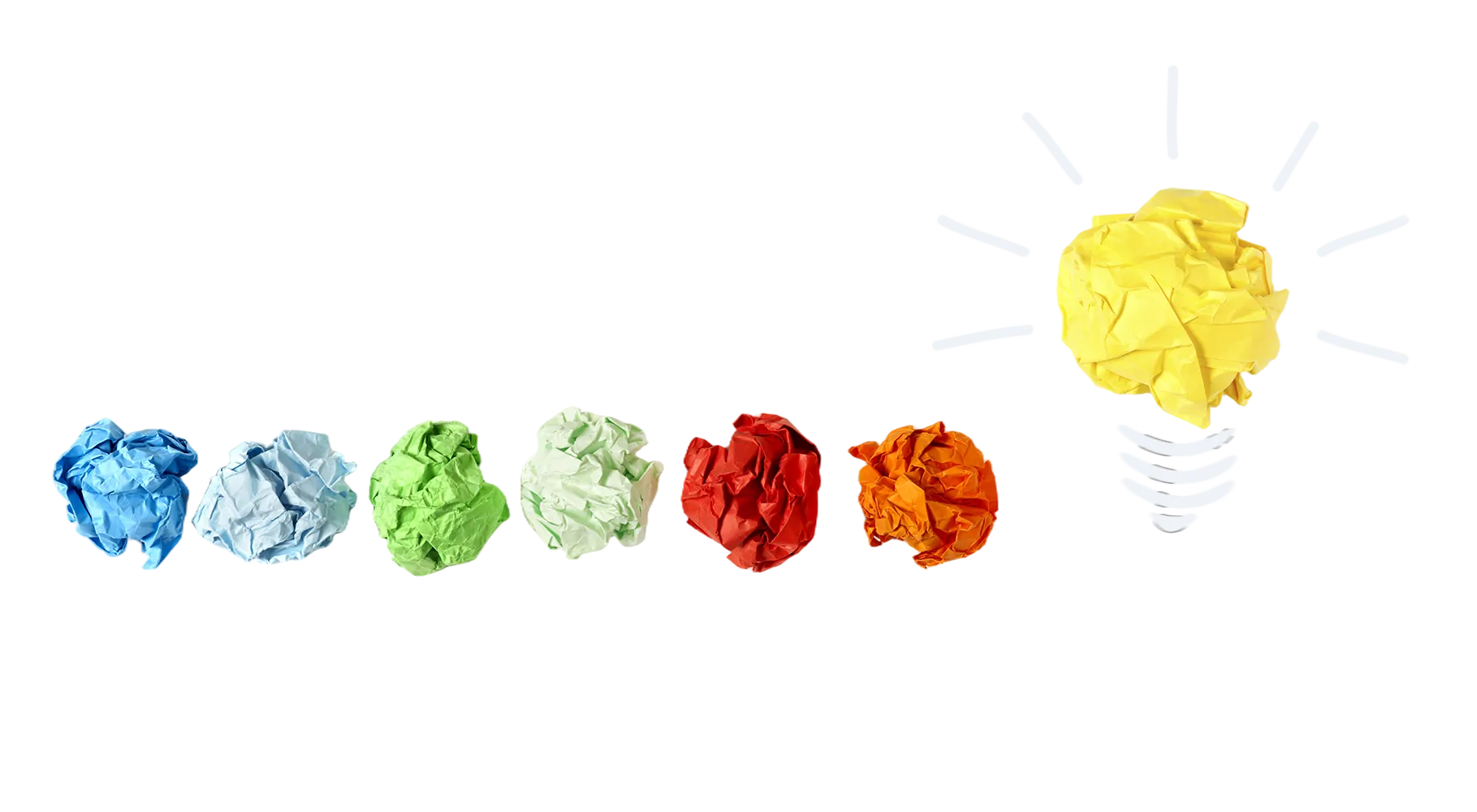Crumpled pieces of paper leading to a lightbulb